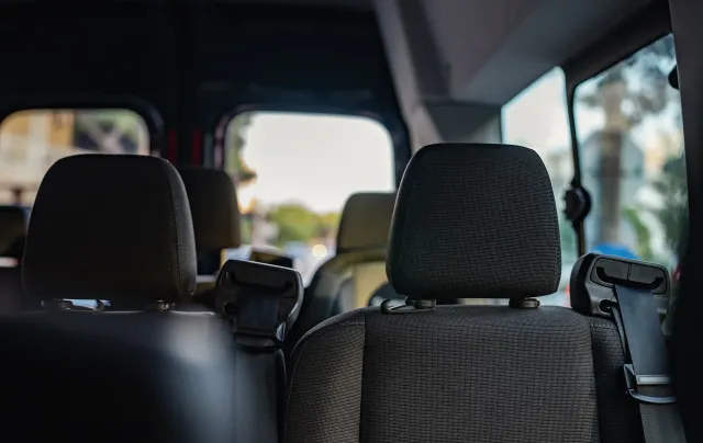 Interior of a van with patterned seat covers for private shuttle Cleveland residents can book.